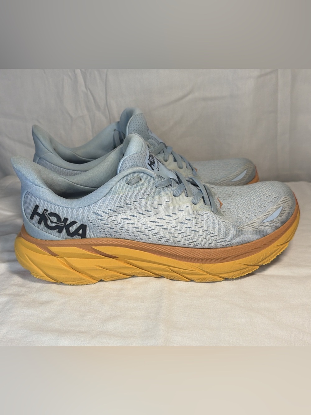Hoka Women's Light Blue Running Shoes with Yellow-Orange Midsole